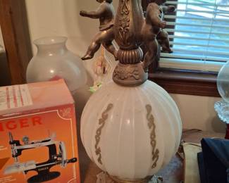 A most unusual lamp with babies attached .
