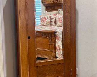 ANTIQUE OAK ARMOIRE WITH BEVELED MIRROR AND SHELVES FOR FOLDED CLOTHES