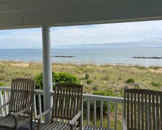 Eight teakwood rocking chairs and a view of the Chesapeake Bay, priceless!