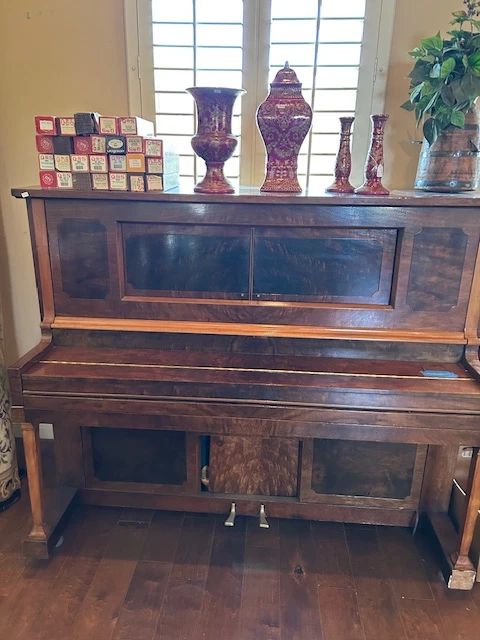 Antique player piano with 26 rolls.  