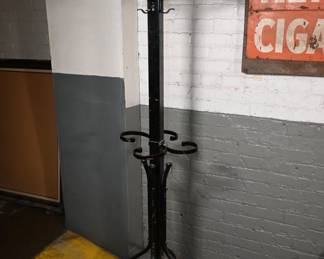 Vintage Industrial Rotating Metal Coat Rack, could easily be positioned as a dark, functional sculpture.