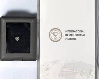 A Brilliant 1.01 CT Heart E VS1 Loose LAB GROWN Diamond In A Display Case With Diamond Report