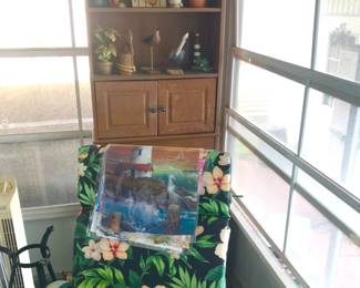 Porch tropical print chairs. Cabinet curio