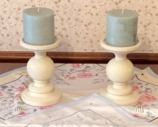 Pair of white candle holders with green candles