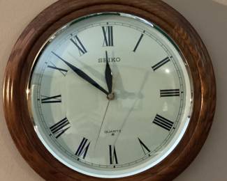 Round wall clock with roman numerals