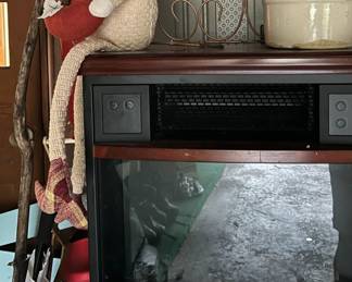 Small electric fireplace and creative sun planter holder and fanciful bearded gnome