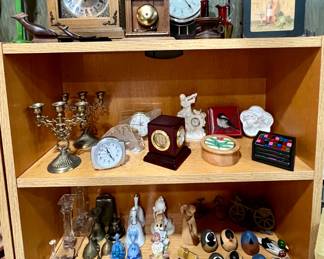 Clocks, brass candle sticks and bells - and birds -- plus a wooden WELCOME sign