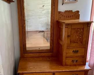 Solid wood and beautifully carved antique bedroom or entryway utility piece - mirror plus small shelf compartment and, two small and two large drawers. 