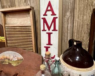 Wooden washboard and FAMILY sign to emit the emotion of togetherness - plus corked bottles and a 'whiskey' jug