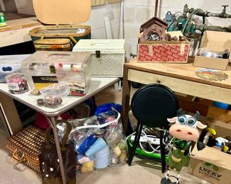 Craft area - guarded by Elsie Cow -- crafts have been gathered by type into bundled carriers for quick purchase - sewing, knitting, quilting, beading, etc.
