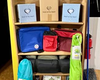 This shelf (for sale also) is filled with new items -- from totes to 'hands held' crafting, doggie toys and tools and a bagged chair and bagged umbrella