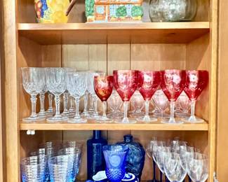 Pitchers or works of art, and sets of stemware - clear cut glass, ruby red, plus assortment of midnight blue stemware, bowl, plate and bottles from Europe