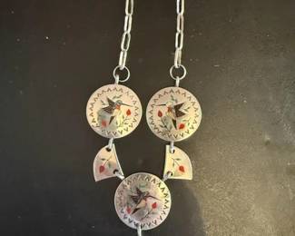 GorgeousSterling silver hummingbird ensemble inlay necklace The Navajo artist's hallmark (Raymond Boyd) and "sterling" are stamped on the back of this necklace. Multi-Stone and Inlay necklace In Zuni culture, the hummingbird is a significant symbol associated with the request for rain as well as a symbol of joy, love, and resilience