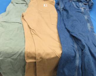 Lot 324. Two pairs of Carhartt pants on one pair of Columbia pants. All in excellent condition. See photos for sizes.