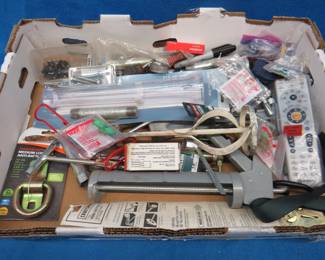 Lot 423. Misc. hardware including a rain gauge, D-ring, Direct TV remote, and more