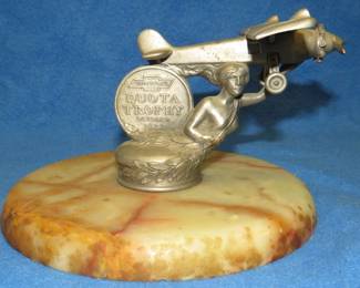 Lot 23. 1927 Chevrolet quota trophy on marble base depicts goddess holding facsimile of Charles Lindberg's Spirit of St. Louis.