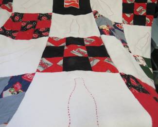 Lot 200. 70" W x 97"L Coca-Cola quilt, some repairs needed