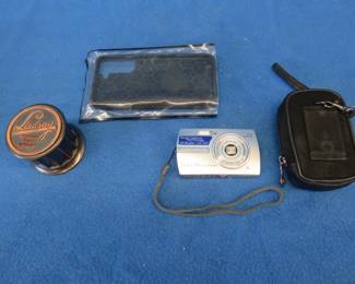 Lot 357. Olympus Stylus 700 All-Weather digital camera with case, phone protector, and an advertising stamp dispenser.