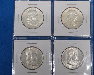 Lot 275. Four Franklin Half-dollars