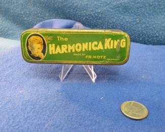 Lot 89. Fr. Hotz gem Harmonica King tin.
