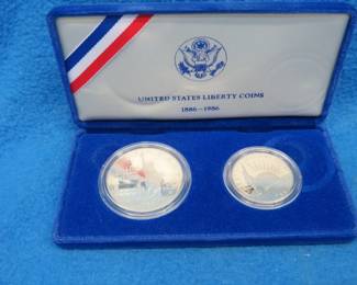 Lot 362. 1986 two-piece Statue of Liberty set containing a 90% silver dollar and a clad half dollar