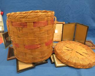Lot 230. Wicker basket and lid with lots of picture frames