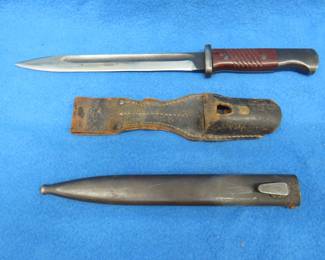 Lot 104. Mauser bayonet and sheath with matching serial numbers. Includes leather frog.