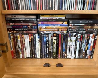 Large collection of DVDs, CDs, and books.