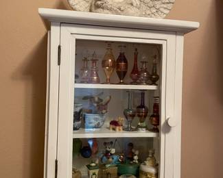 Display case and lots of littles. Vintage perfume bottles
