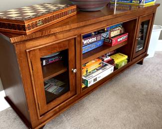 Storage credenza with glass front cupboards and open shelves.