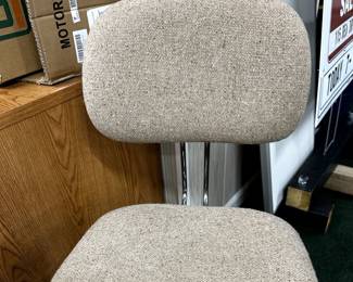 Office desk chair (we have two different ones) on wheels with adjustable seat and back.