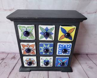 Jewelry boxed sized chest of drawers. Wood and ceramic.