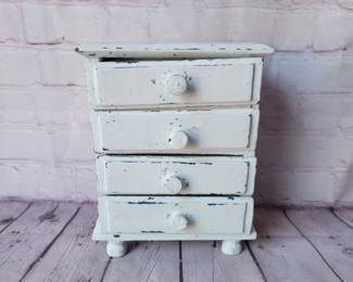 Jewelry box sized chest of drawers. Several layers of paint.