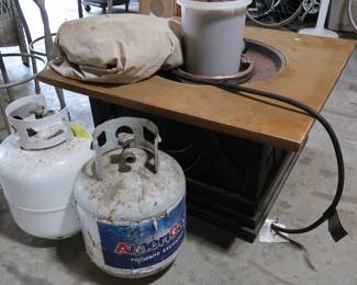 Lava rocks and two propane tanks supply this fun bon fire 