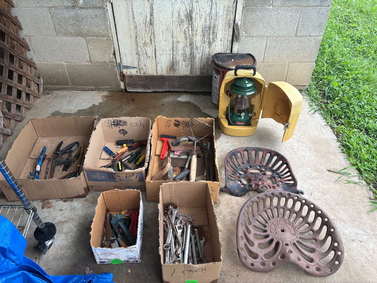 Vintage tractor seats, tools, coleman lantern in case