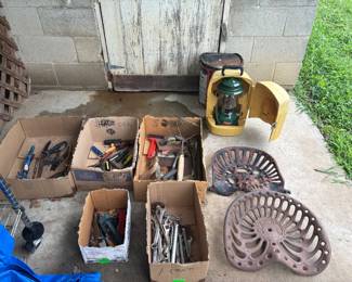 Vintage tractor seats, tools, coleman lantern in case