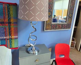 side table, whimsical lamp, colorful mirror, and child's chair