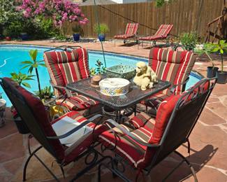 Outdoor patio table with 4 chairs, 2 chaise loungers all with matching cushions