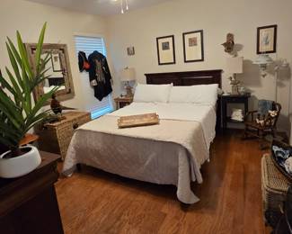 This picture is full of a variety of available items. Queen headboard, mattress/box spring with metal frame, side tables, matching pair of lamps, taxidermy, large eye-catching mirror, woven basket-chests, wall art, and more!