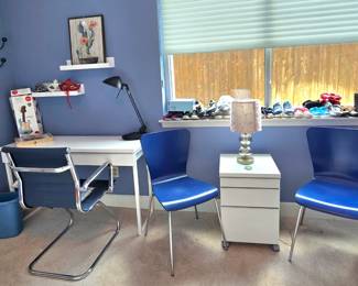 white desk, accent chairs and modular storage cabinet