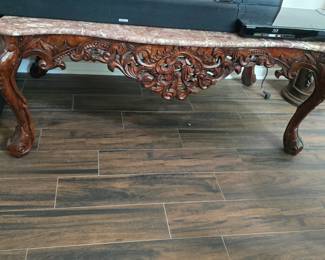 beautifully carved, pink marble-topped coffee table