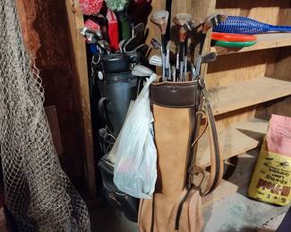Two sets of golf clubs and other golf equipment