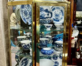 Curio cabinet with blue and white decor with stands