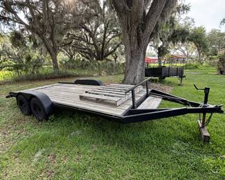 Flatbed trailer, ramps included, but not pictured.