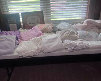 Assortment of bedding and wall pictures.