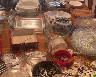 Vintage tin full of buttons. crystal platters, cookware, and mixing bowls.