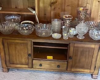 Entertainment cabinet, crystal bowls, and other glassware.