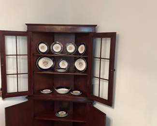This is an Antique Petite Corner Cabinet.
