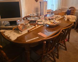 Dining room table with miscellaneous collectibles, dishes. & monitor - large click on wall.