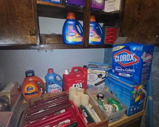Cleaning supplies along with candles, miscellaneous tape in separate box